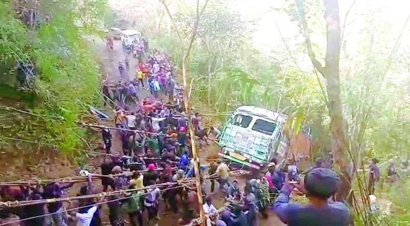 A screen-grab from a video showing the people of Kutsapo pulling up a truck which had fallen off the road.